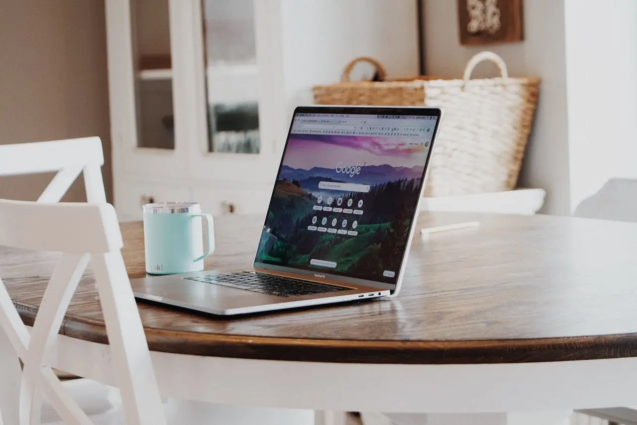 MacBook on Brown Wooden Table